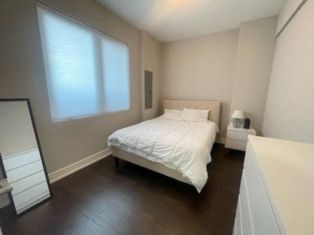 bedroom with dark hardwood / wood-style floors