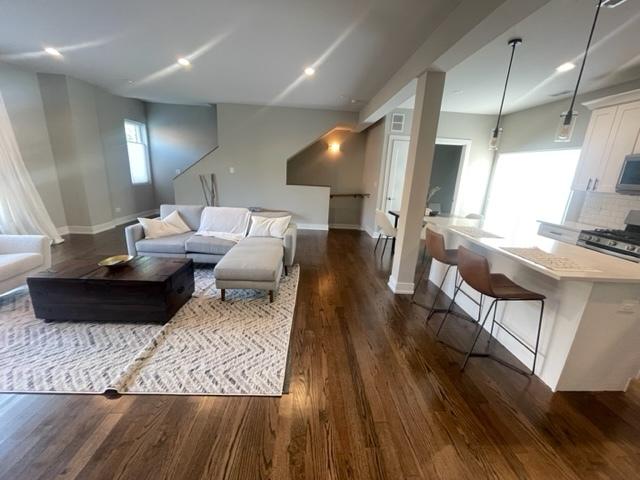 living room featuring dark wood-type flooring