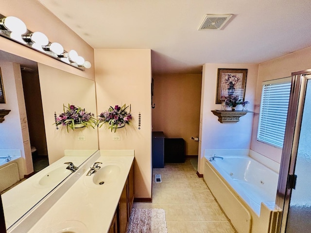 bathroom with vanity, tile patterned flooring, and a bathtub