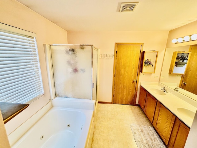 bathroom with vanity and independent shower and bath