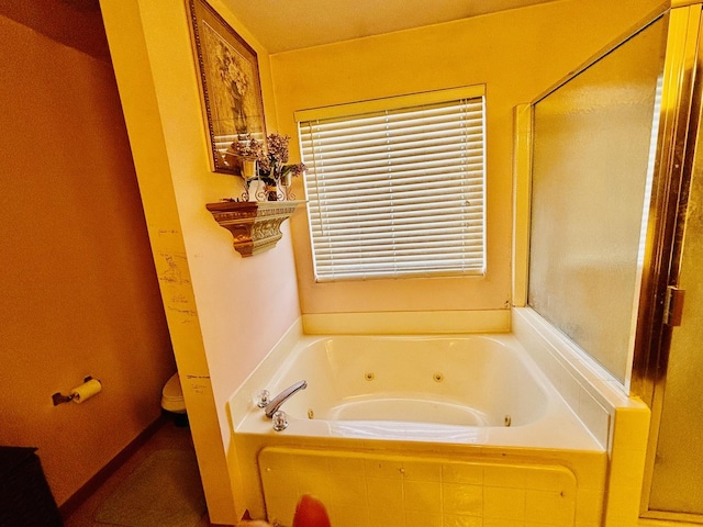 bathroom featuring toilet and separate shower and tub