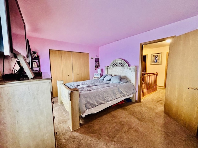 bedroom with light colored carpet and a closet