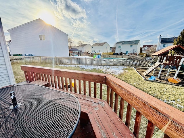 deck featuring a playground and a lawn