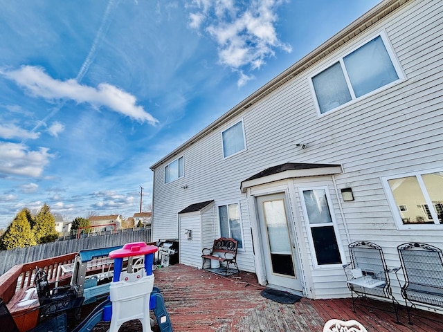 rear view of house featuring a wooden deck