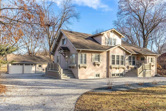 view of front of home with a garage and an outdoor structure