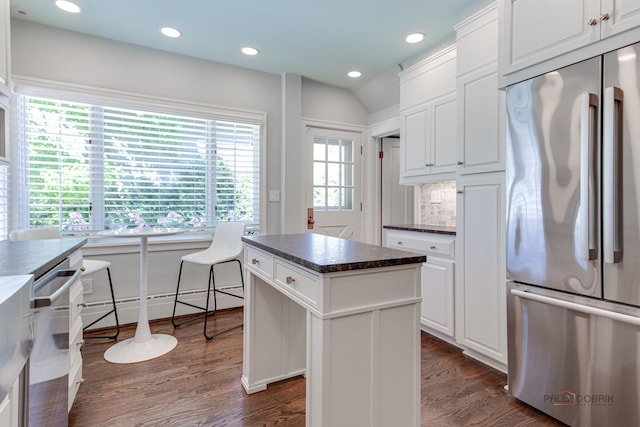 kitchen featuring white cabinetry, dark hardwood / wood-style floors, a center island, and appliances with stainless steel finishes