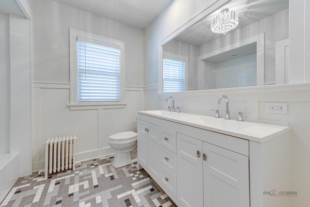 bathroom featuring radiator heating unit, vanity, a notable chandelier, toilet, and tile patterned floors