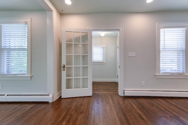 doorway to outside with a baseboard radiator and dark hardwood / wood-style floors