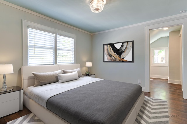 bedroom with dark wood-type flooring, crown molding, and multiple windows