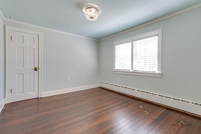 spare room with crown molding, dark hardwood / wood-style floors, and baseboard heating