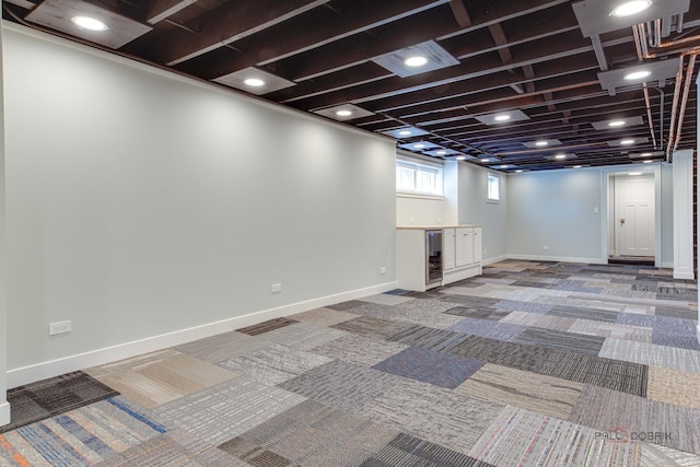 basement with wine cooler and carpet flooring