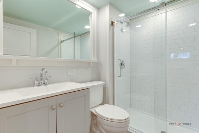 bathroom with vanity, an enclosed shower, and toilet