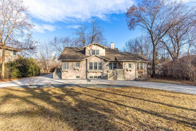 view of front of property with a garage and a front lawn