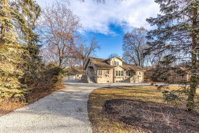 view of front of house with a garage and an outdoor structure