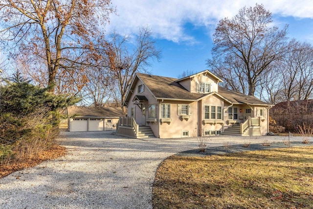 view of front of house featuring a garage and an outdoor structure