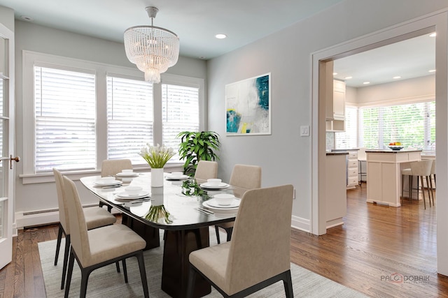 dining room featuring hardwood / wood-style floors and an inviting chandelier