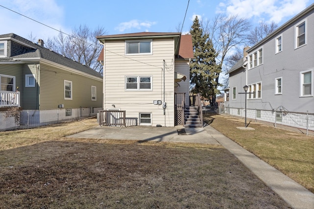 back of house with a patio and a lawn