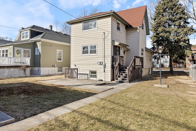 rear view of property with a patio area and a lawn