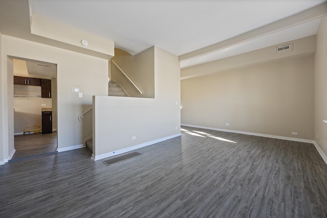 unfurnished room with dark wood-type flooring