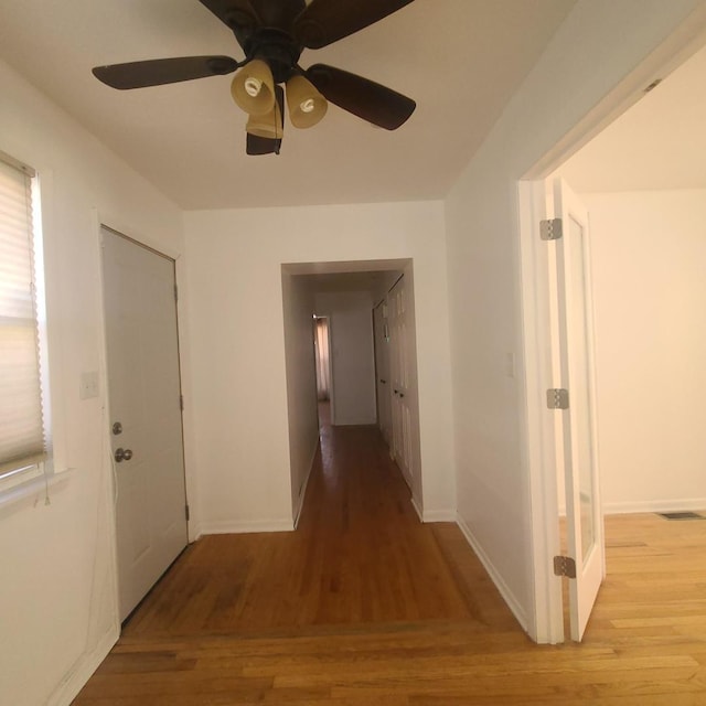 hallway with light hardwood / wood-style floors