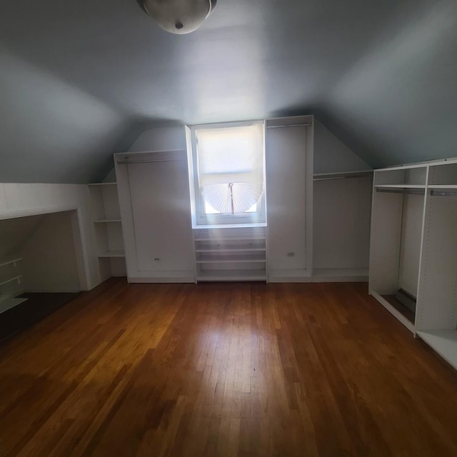 bonus room featuring vaulted ceiling and dark hardwood / wood-style floors