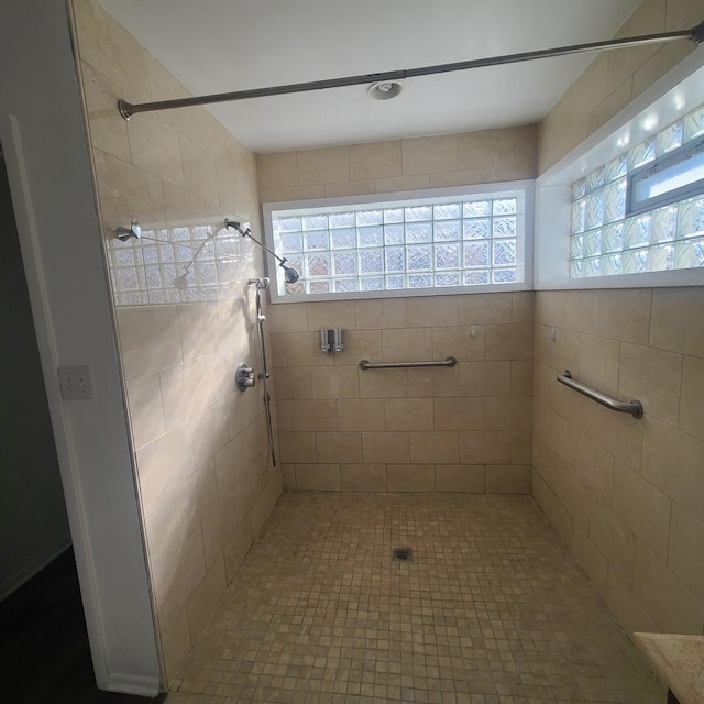 bathroom with a tile shower