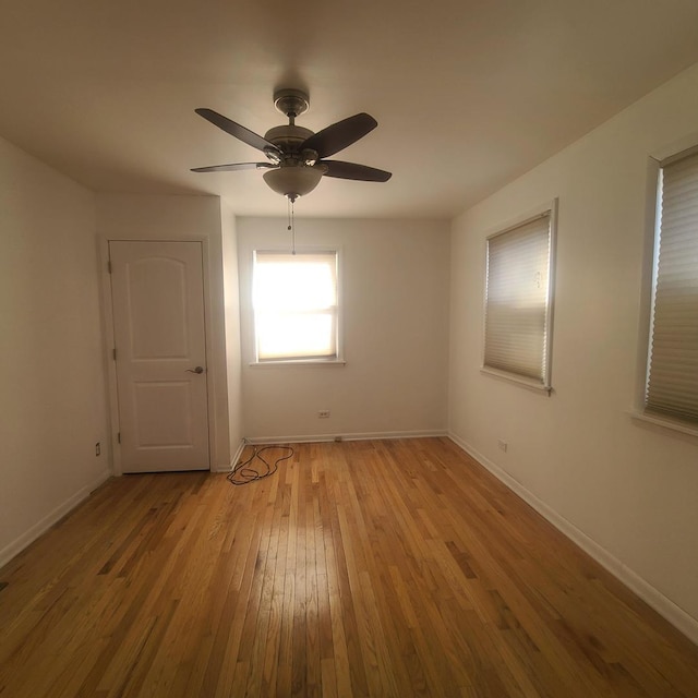 empty room featuring ceiling fan and light hardwood / wood-style flooring