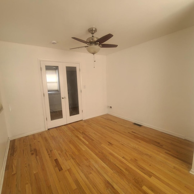 spare room featuring ceiling fan, light hardwood / wood-style floors, and french doors