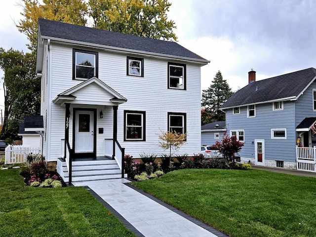 colonial-style house featuring a front yard