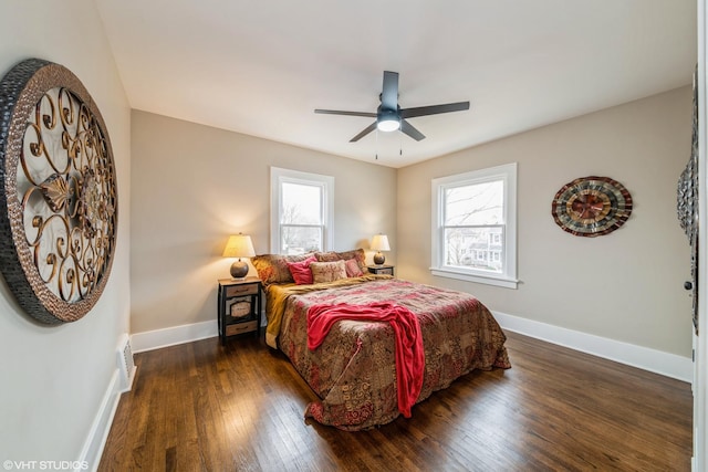 bedroom with ceiling fan and dark hardwood / wood-style flooring