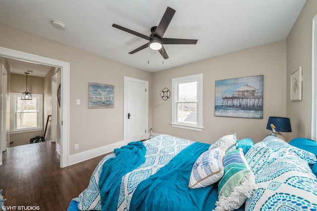 bedroom with dark wood-type flooring and ceiling fan