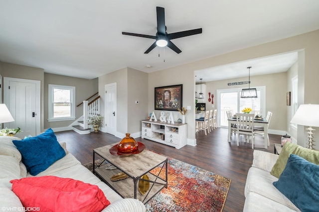 living room with dark hardwood / wood-style floors and ceiling fan