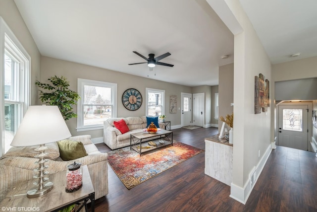 living room featuring ceiling fan and dark hardwood / wood-style floors