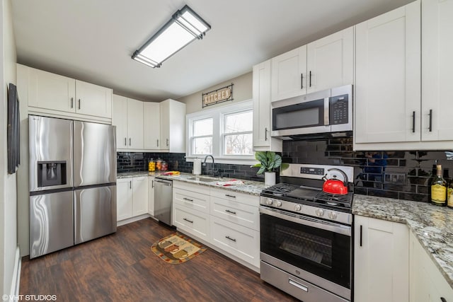 kitchen with appliances with stainless steel finishes, sink, and white cabinets