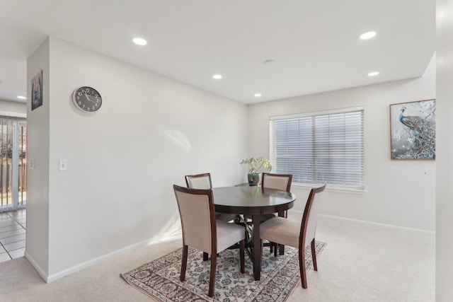 dining area featuring plenty of natural light and light carpet