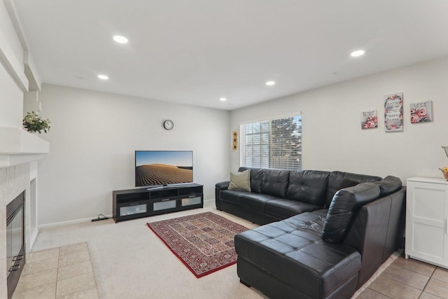 carpeted living room featuring a tile fireplace