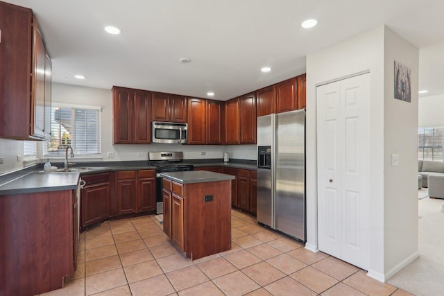 kitchen featuring sink, a wealth of natural light, stainless steel appliances, and a center island