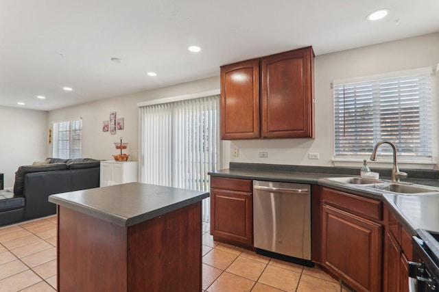 kitchen featuring light tile patterned flooring, stainless steel dishwasher, range, and sink