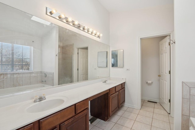 bathroom with vanity, shower with separate bathtub, and tile patterned flooring