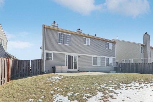 rear view of property with a yard and a patio area