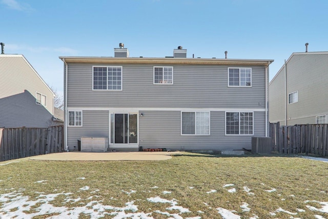 rear view of property featuring a patio area and a lawn