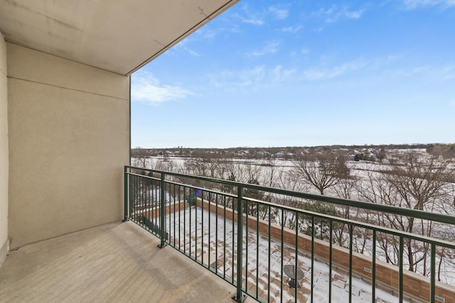 view of snow covered back of property