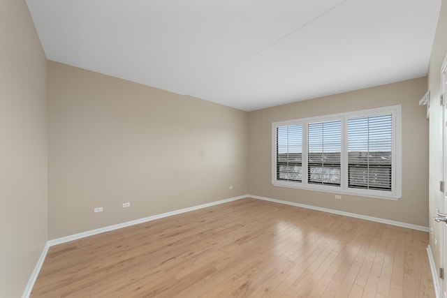 spare room with light hardwood / wood-style flooring