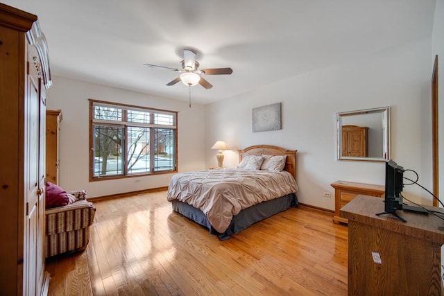 bedroom with ceiling fan and light hardwood / wood-style floors