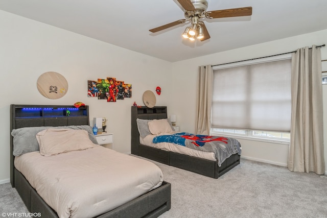 bedroom featuring light colored carpet and ceiling fan