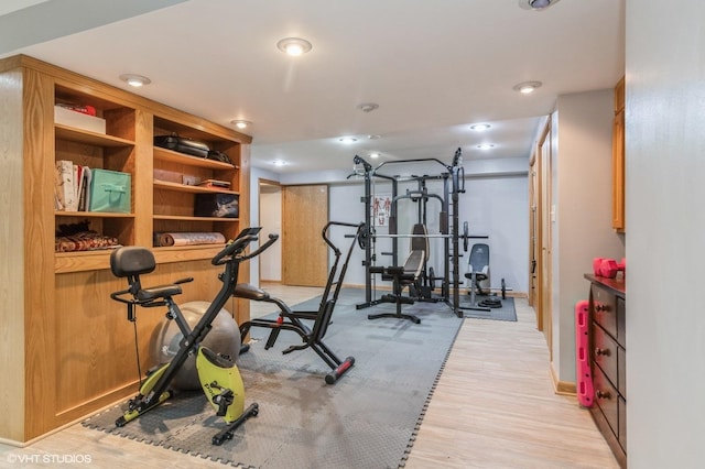 workout room featuring light wood-type flooring