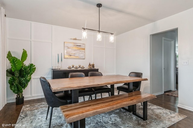 dining space with dark wood-type flooring