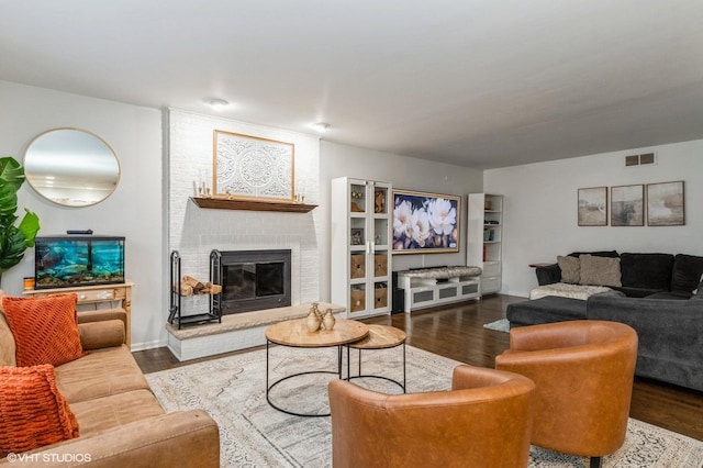 living room featuring a fireplace and dark hardwood / wood-style floors