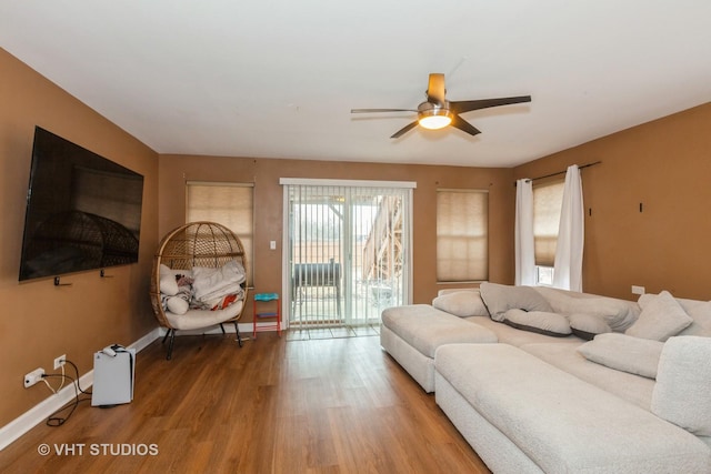 living room featuring ceiling fan and hardwood / wood-style floors