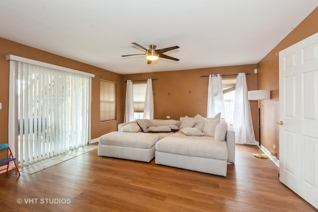 living room featuring wood-type flooring and ceiling fan